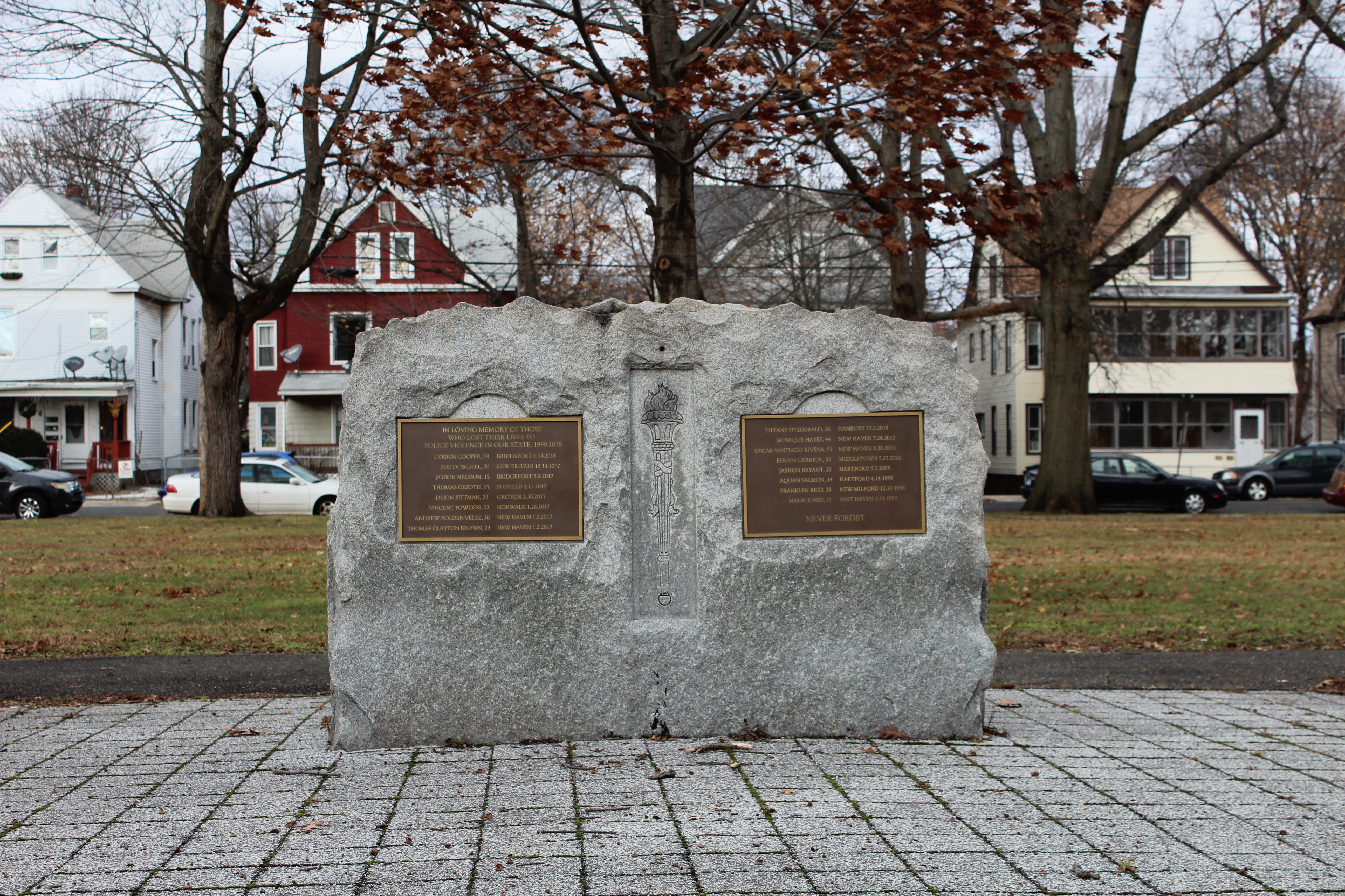 Photograph of monument with plaques listing names of those killed by police in Connecticut